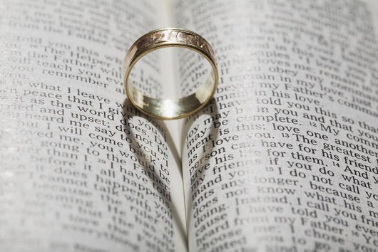 Close up of a gold ring with the shadow of an heart Wall Mural