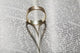 Close up of a gold ring with the shadow of an heart Wall Mural