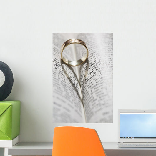 Close up of a gold ring with the shadow of an heart Wall Mural