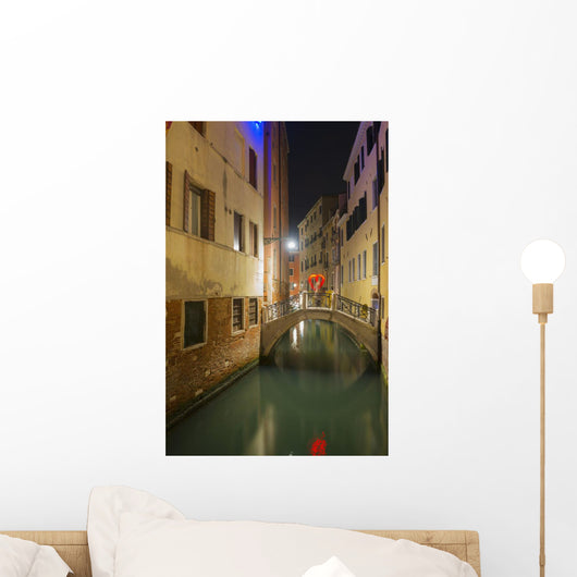 A tranquil canal between buildings with a heart shape on a footbridge Wall Mural