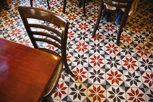 Decorative black and white pattern on the flooring of a restaurant Wall Mural