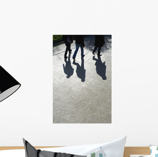 Pedestrians and their shadows on a walkway Wall Mural