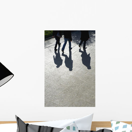 Pedestrians and their shadows on a walkway Wall Mural