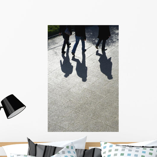 Pedestrians and their shadows on a walkway Wall Mural