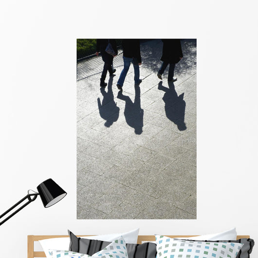Pedestrians and their shadows on a walkway Wall Mural