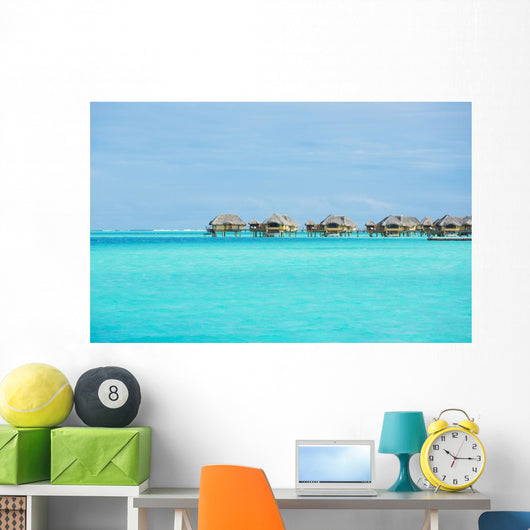 Over-water bungalows at a tropical resort Wall Mural