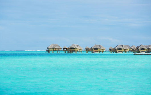 Over-water bungalows at a tropical resort Wall Mural
