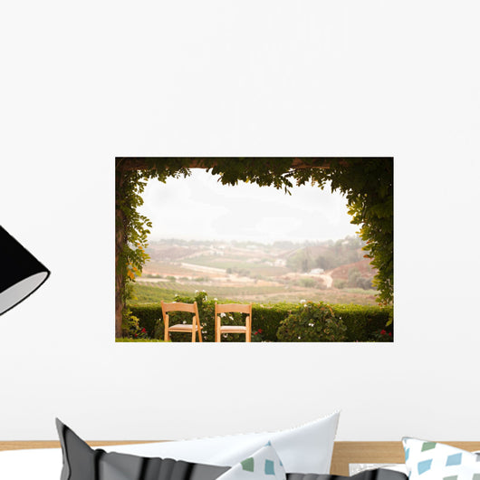 Vine Covered Patio and Chairs Overlooking the Country Wall Mural