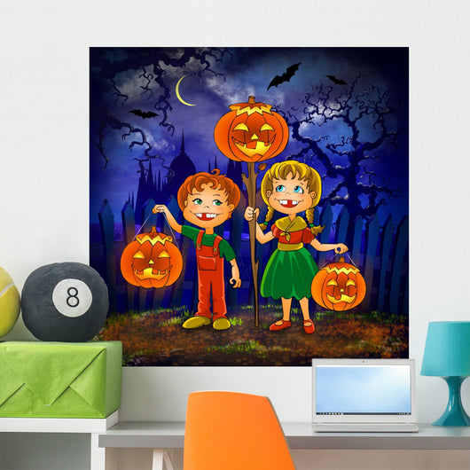 Boy and girl with pumpkins celebrates halloween. Wall Mural