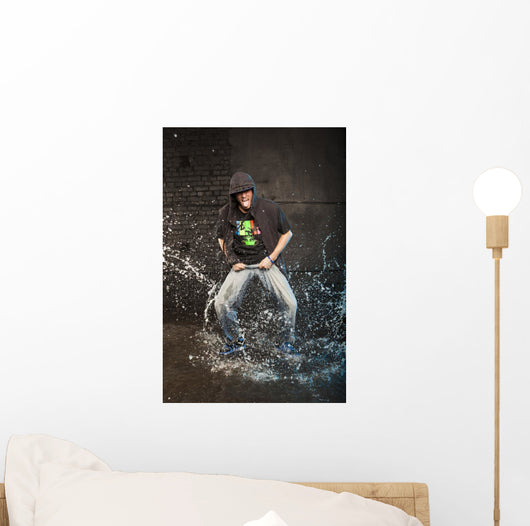 Hip-hop dancer in aqua studio showin his tongue Wall Mural