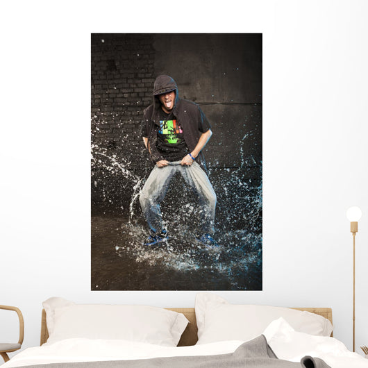 Hip-hop dancer in aqua studio showin his tongue Wall Mural