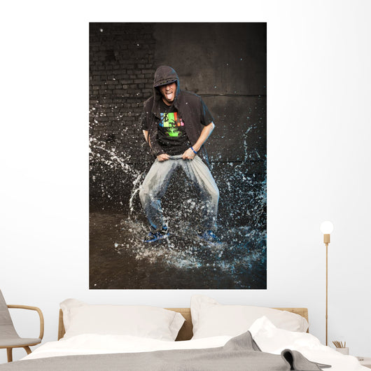 Hip-hop dancer in aqua studio showin his tongue Wall Mural