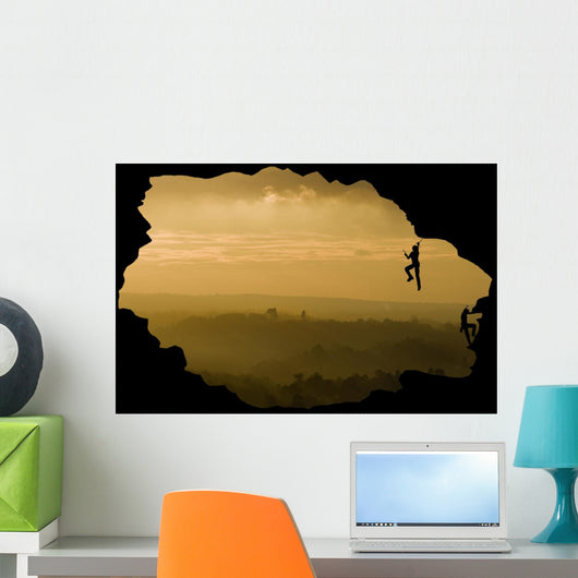 Two rock climbers silhouette against stunning sunset landscape c Wall Mural