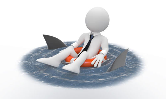 Businessman floating in a life preserver with sharks around Wall Decal
