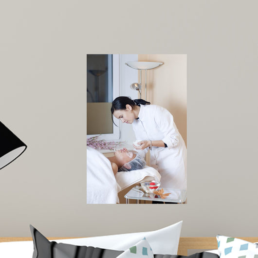 Beautician applying facial mask Wall Mural