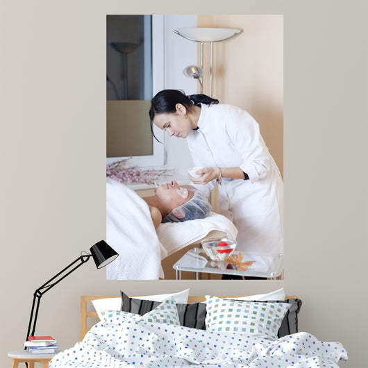 Beautician applying facial mask Wall Mural