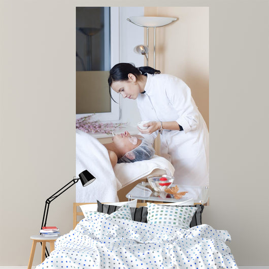Beautician applying facial mask Wall Mural