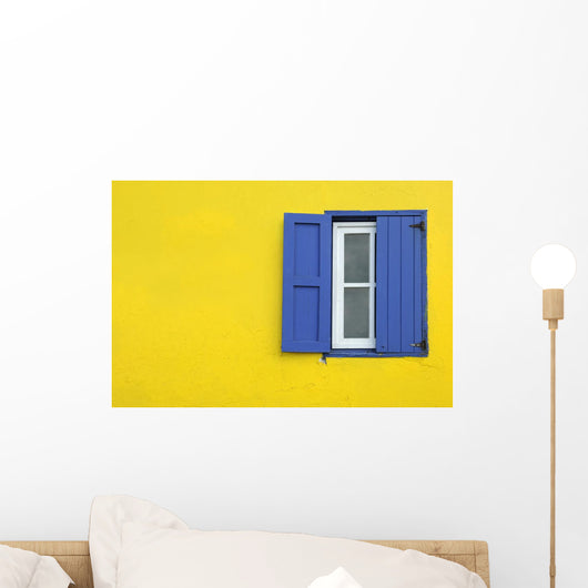 Colorful yellow house with blue shutters in Governor's Harbour Wall Mural