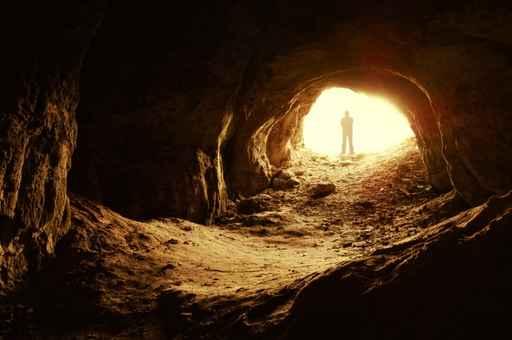 Man Standing Front Cave Wall Decal