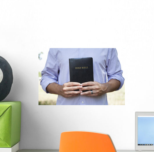 Man Holding Black Bible