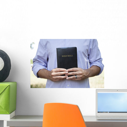 Man Holding Black Bible