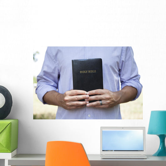 Man Holding Black Bible