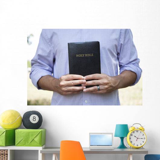 Man Holding Black Bible