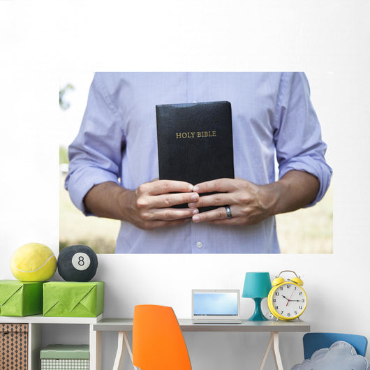 Man Holding Black Bible