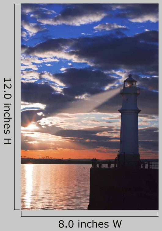 Lighthouse at sunset with light beam Wall Mural