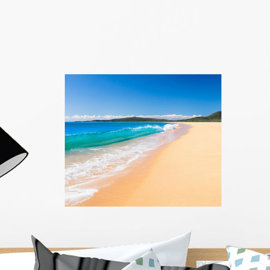 A Perfect Wave Rolls Onto the Beach Wall Mural