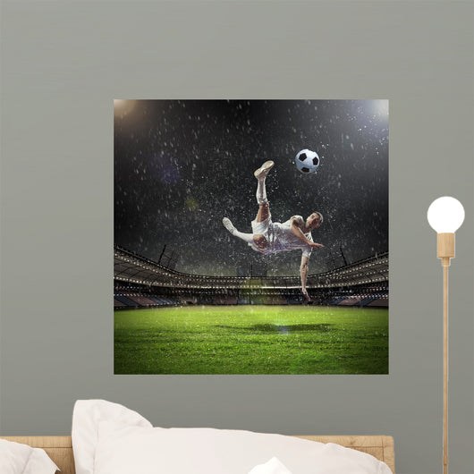 Football Player Striking Ball