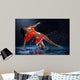 Woman dancing under rain in orange dress. Studio Wall Mural