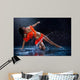 Woman dancing under rain in orange dress. Studio Wall Mural