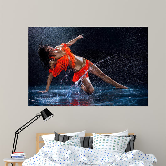 Woman dancing under rain in orange dress. Studio Wall Mural