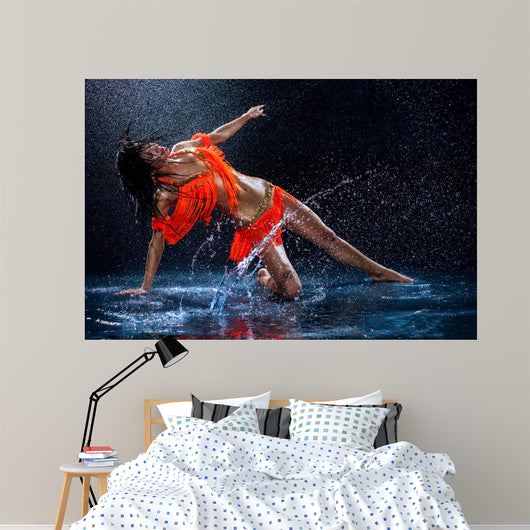Woman dancing under rain in orange dress. Studio Wall Mural