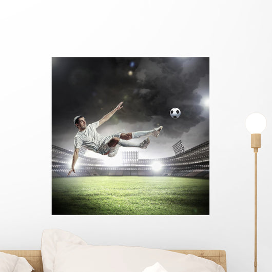 Football Player Striking Ball