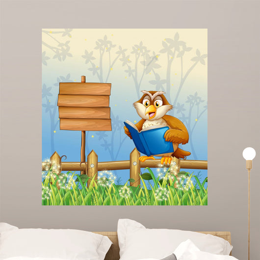 An owl reading a book beside a wooden signboard Wall Mural