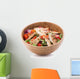 Grilled chicken salad in wooden bowl isolated on white Wall Decal