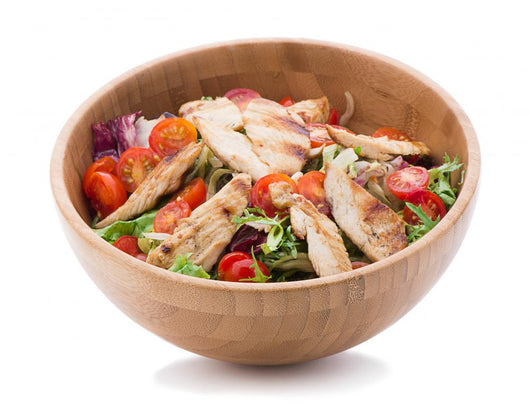 Grilled chicken salad in wooden bowl isolated on white Wall Decal