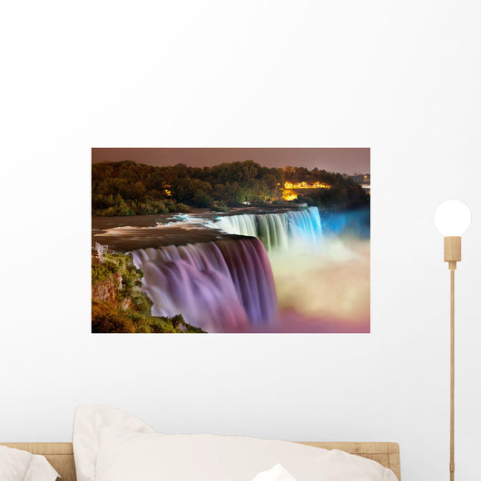 Niagara Falls lit at night by colorful lights