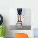 teenage girl standing on top of a stack of books Wall Mural