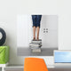 teenage girl standing on top of a stack of books Wall Mural