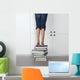 teenage girl standing on top of a stack of books Wall Mural