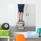 teenage girl standing on top of a stack of books Wall Mural