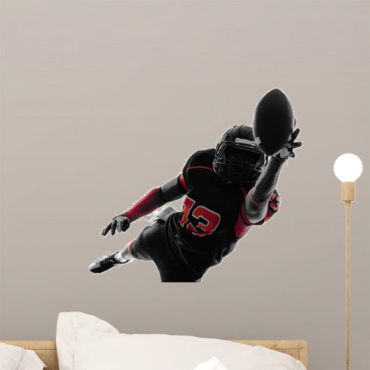 american football player catching ball silhouette