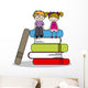 kids sitting on books