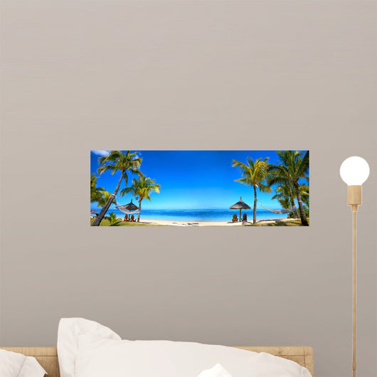 Tropical beach panorama with chairs and umbrellas