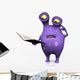 A spotted monster reading book and looking confused.