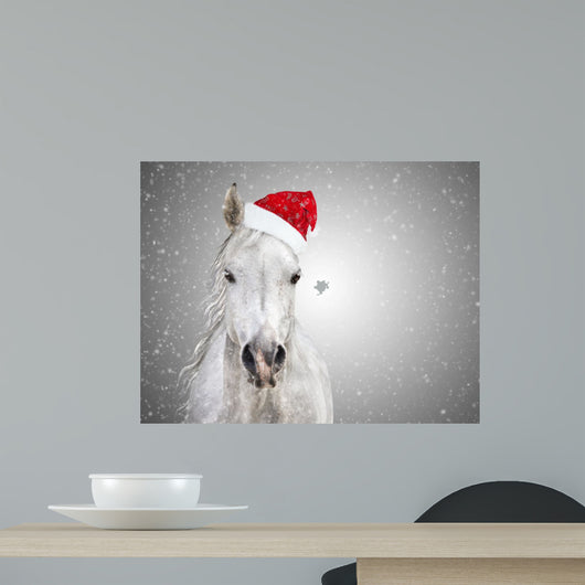 White christmas horse with santa hat on gray background snowfall