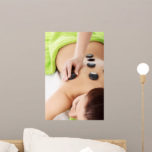 Beautiful woman lying on spa salon.